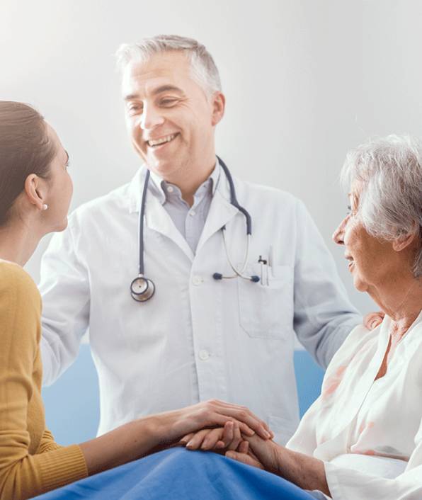 A healthcare professional providing supportive services to an elderly patient at Sunray ADHC, representing the wide range of care and assistance available